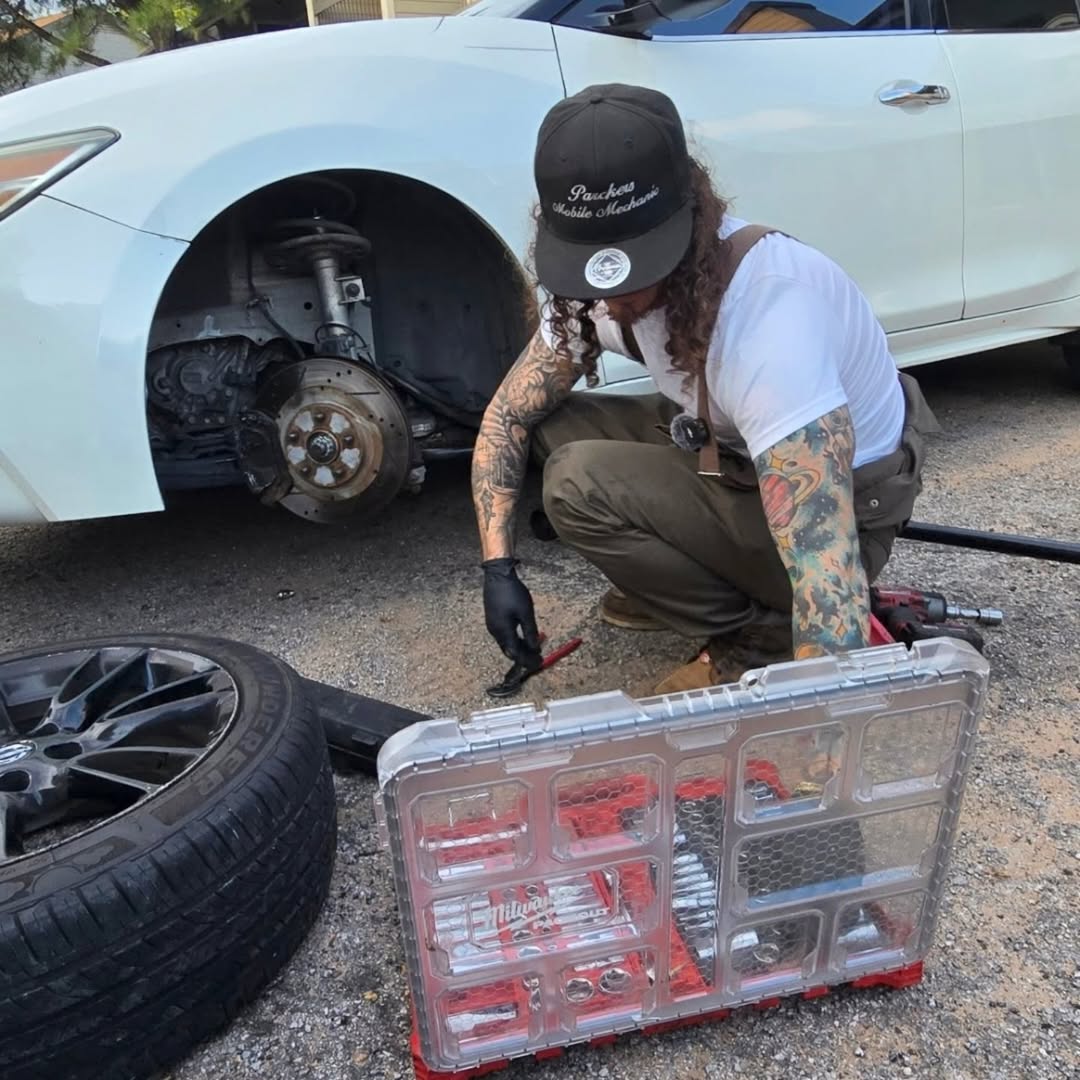 Parker working on a customer's brakes on location