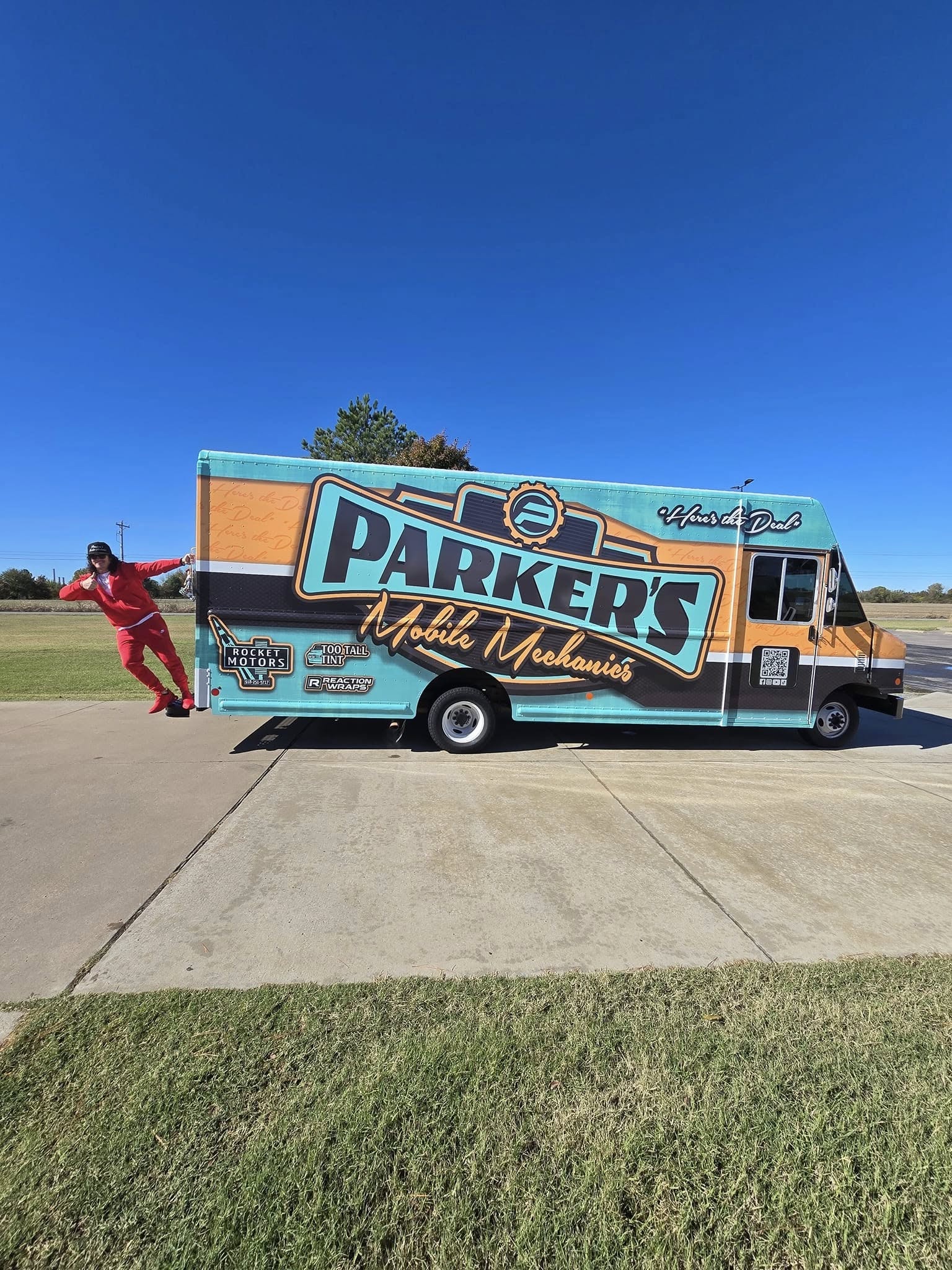 Parker beside the wrapped Parker's Mobile Mechanics service truck